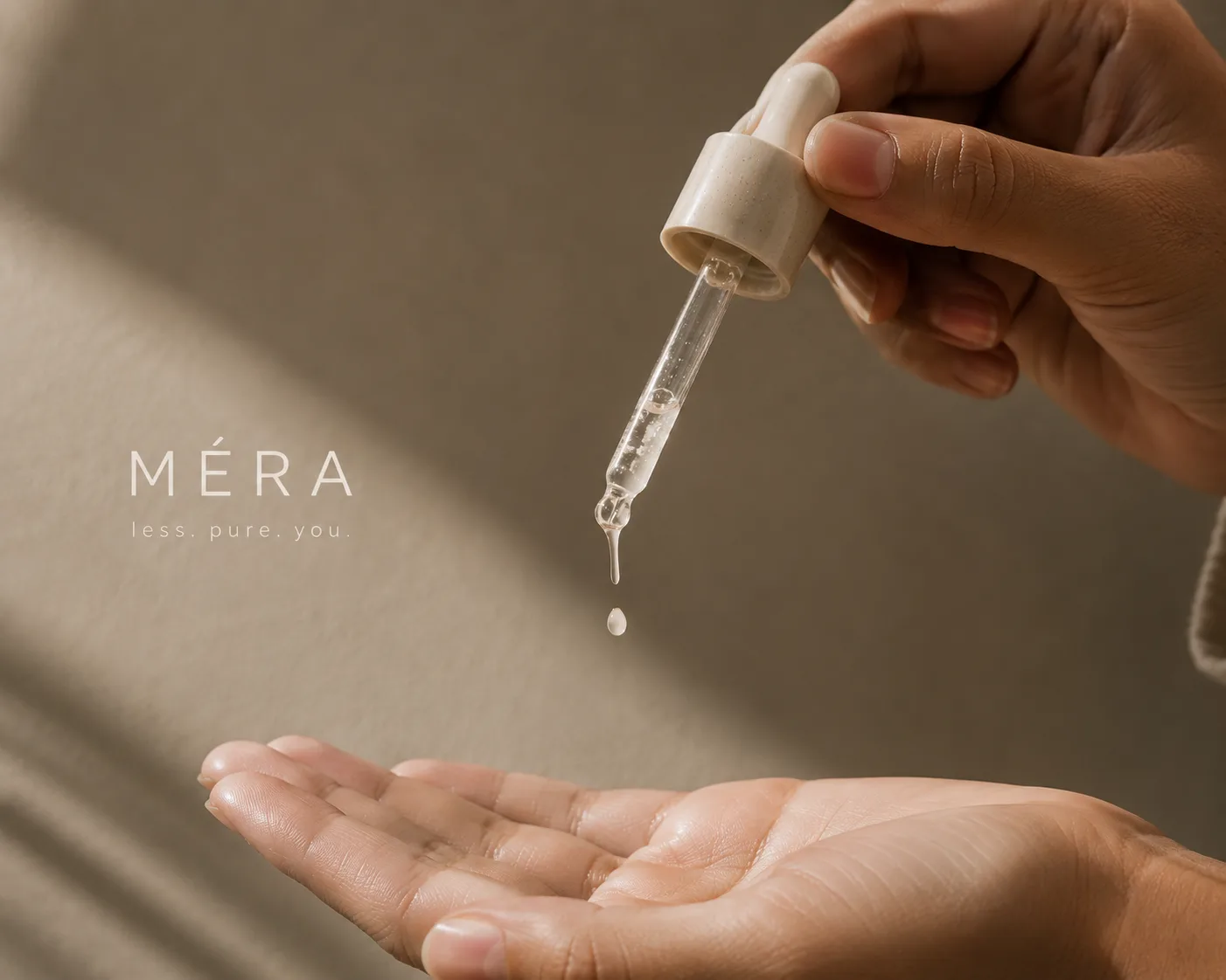Hand holding a dropper above an open palm, Méra wordmark on the wall behind
